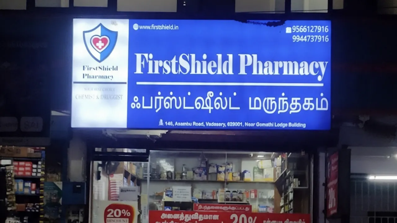FirstShield Pharmacy storefront with its lit signboard
